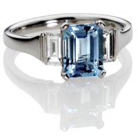 example image of a platinum engagement ring set with an Aqua-marine stone and diamond side stones